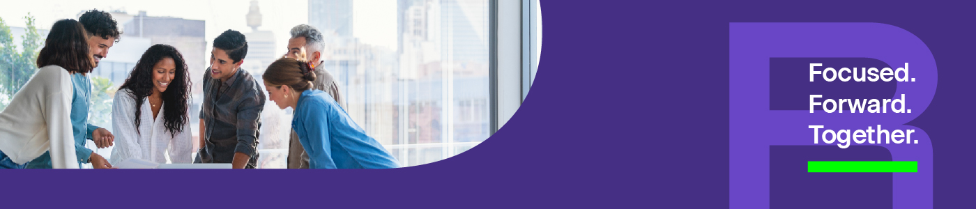 Image of colleagues gathered around laptop smiling. 