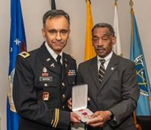 Photo: U.S. Army Col. Mohammad Naeem, MD, FACR, at left, receives award from Jonathan Woodson, MD.