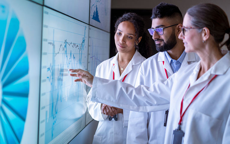 Stock photo: Group of researchers look at Health Equity statistics (getty images)