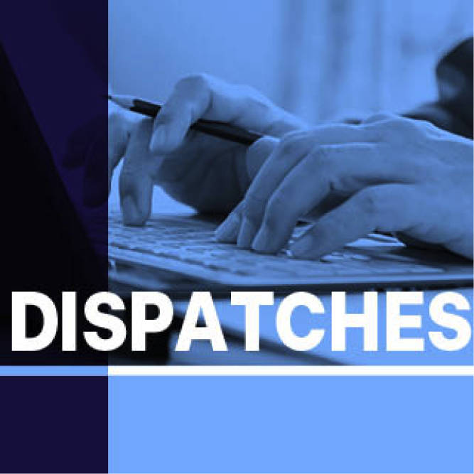 blue tinted close up of hands typing