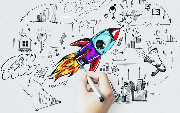 Photo of hand drawing a rocket in the middle of a strategic plan diagram