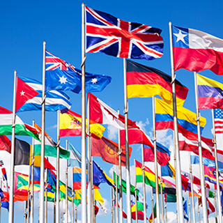 Flagpoles flying flags from many different countries