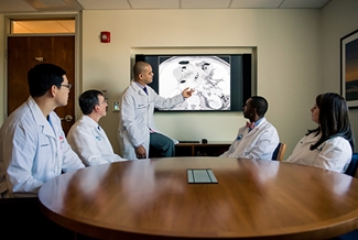 Efren Flores show imaging to colleagues