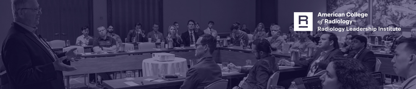 Image of people listening to a conference session