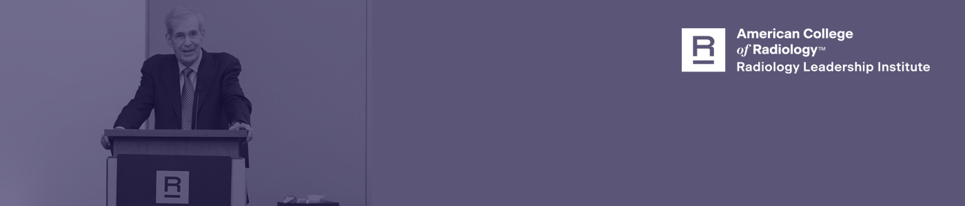 Image of a man speaking at a podium