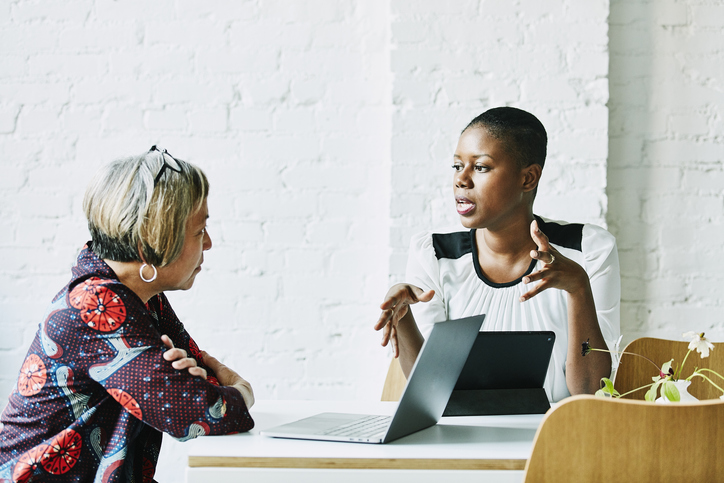 Two women at a table talking